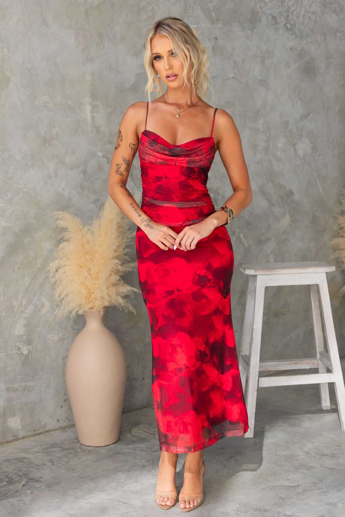 Emiliano Midi Dress featuring adjustable straps and fabric overlay, styled in vibrant red floral design.