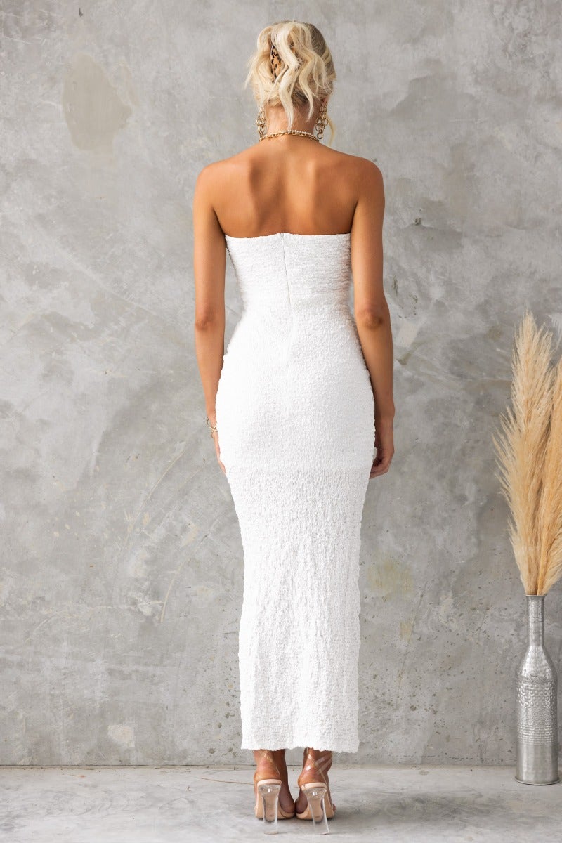 Model wearing strapless Hollywood Maxi Dress in textured white material, showcasing a fitted silhouette.