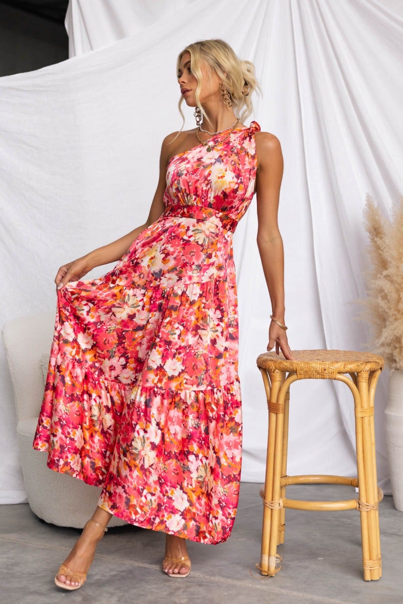 Carmen Midi Dress featuring floral print, one-shoulder neckline, and a flowing silhouette perfect for summer events.