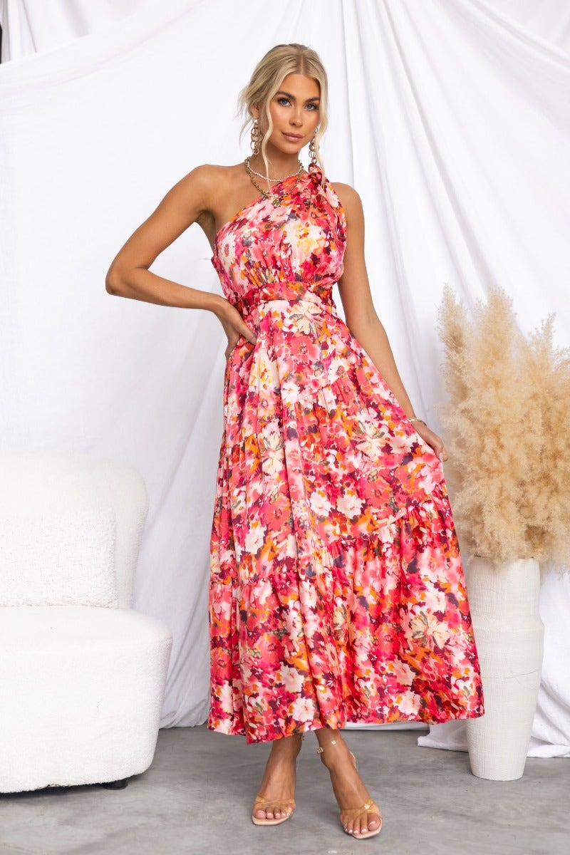 Carmen Midi Dress features a floral print, one-shoulder neckline, and side pockets, perfect for a stylish summer look.