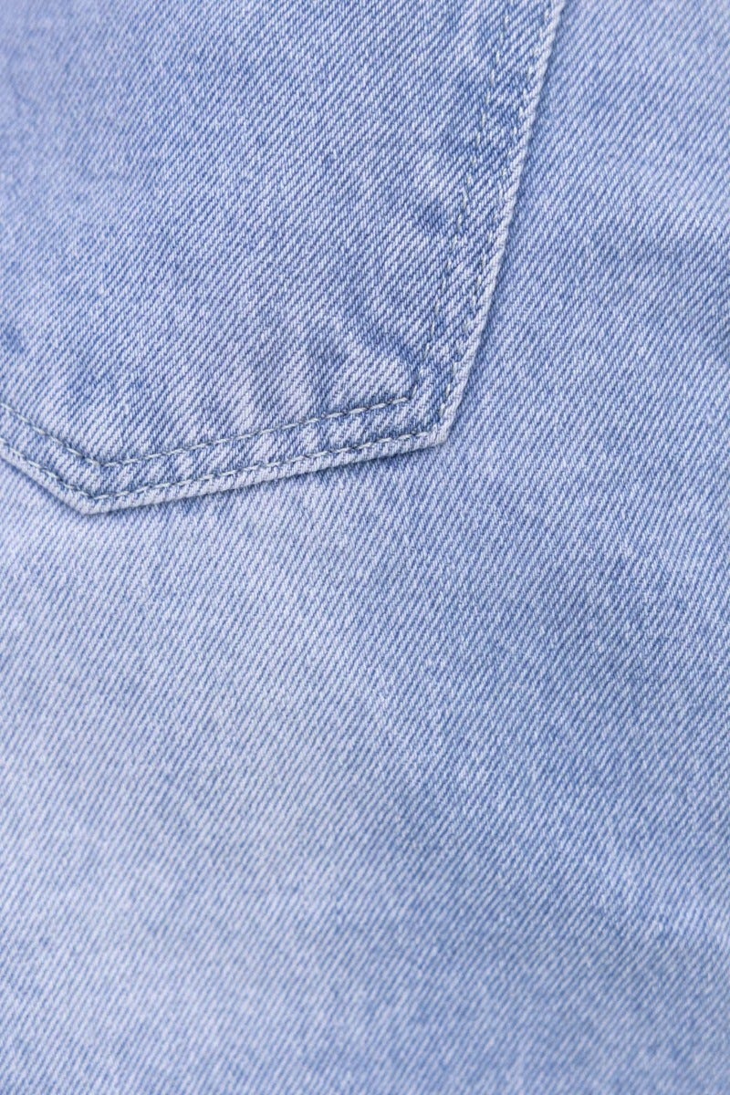 Close-up of the blue denim fabric showing stitching detail and pocket design of Denver Denim Shorts.
