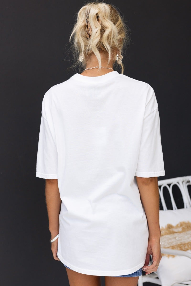 Back view of the Duke Top white oversized tee with round neckline in a casual setting.