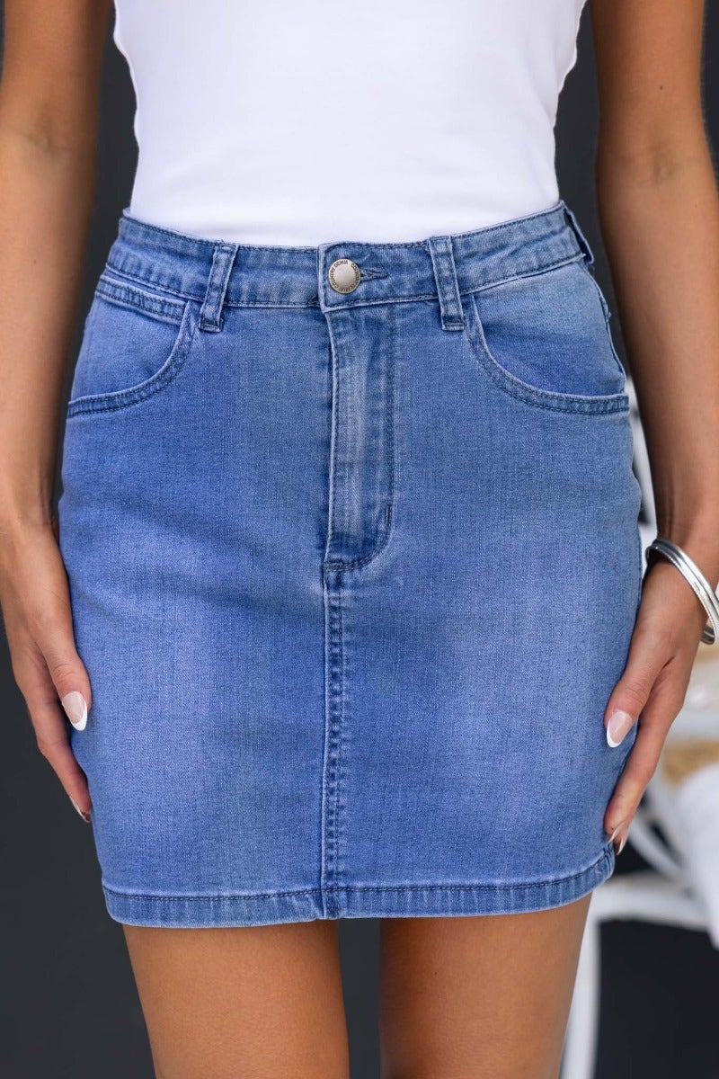 Alley Denim Skirt in pencil style with front and back pockets, made from stretch denim, shown on model.