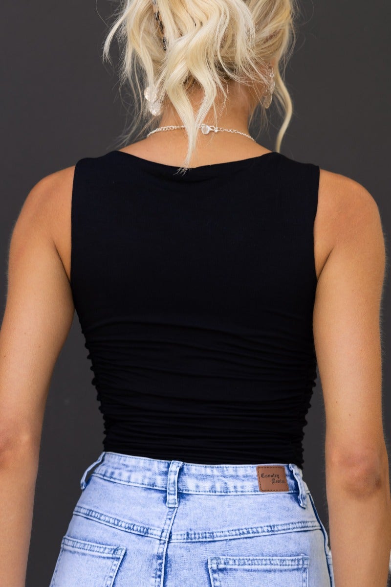 Back view of Emily Bodysuit, featuring a black sleeveless design with ruching detail.