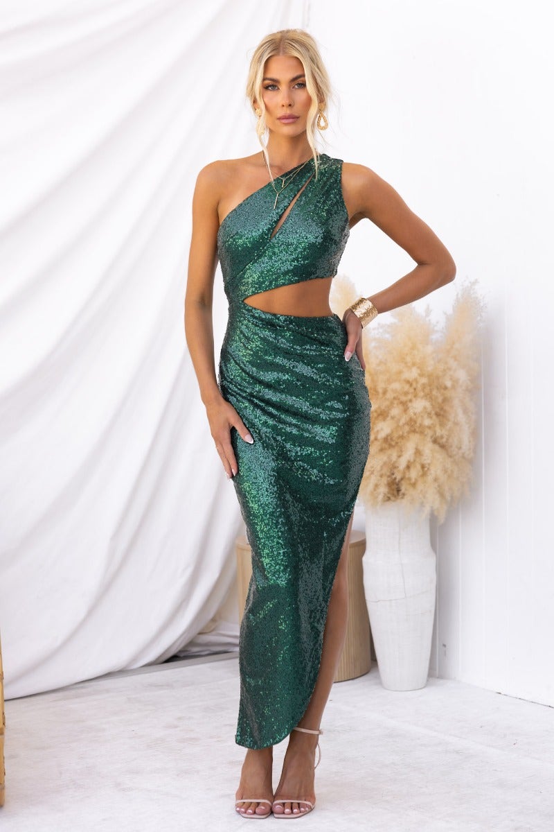 Elegant green Honoured Maxi Dress featuring a one-shoulder design and side cutout, styled with chic accessories.