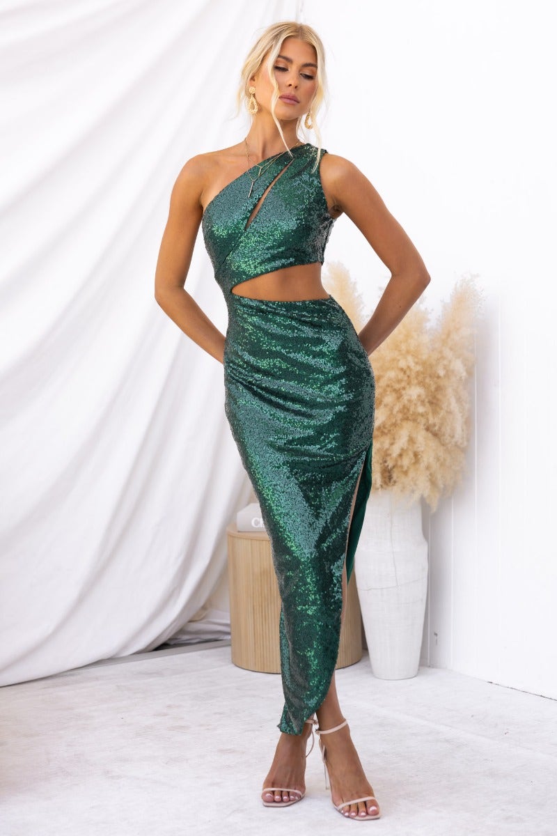 Green sequined Honoured Maxi Dress featuring a one-shoulder design and side slit, styled with strappy heels.