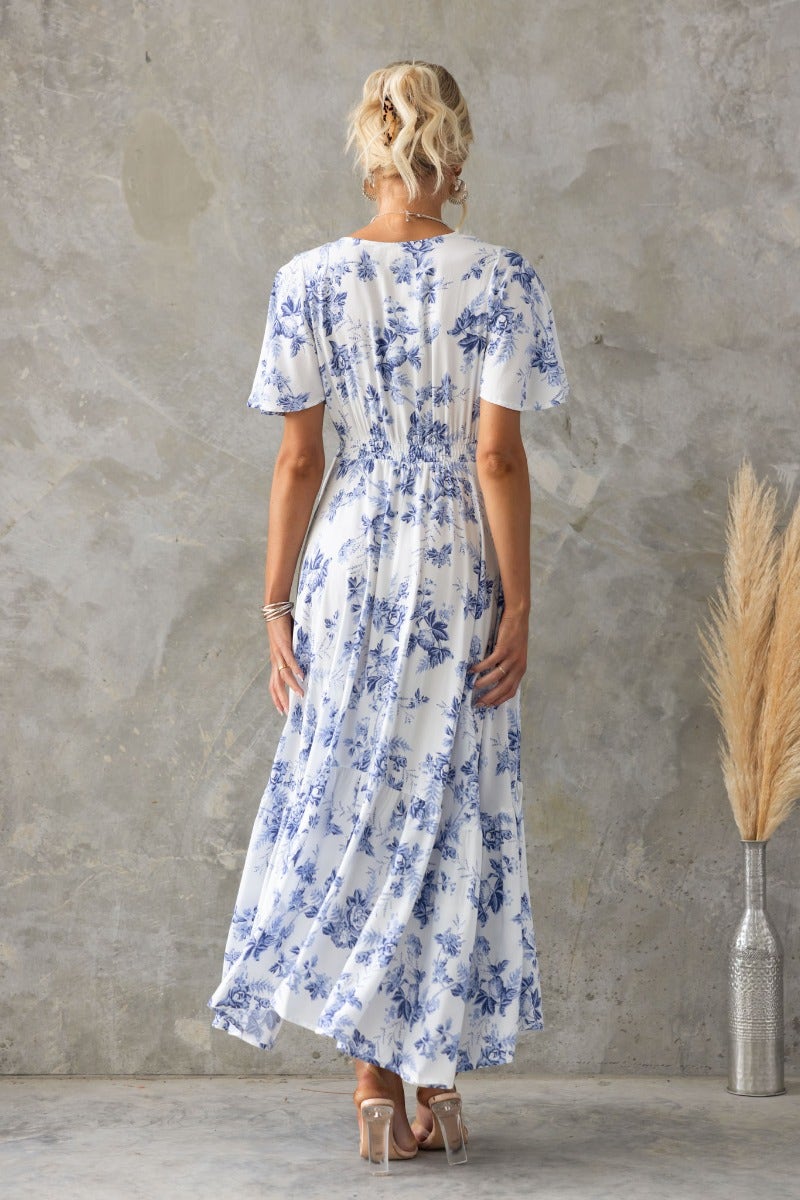 Back view of a floral print Nashville Maxi Dress with V-neckline and elastic waist, perfect for warm weather styling.