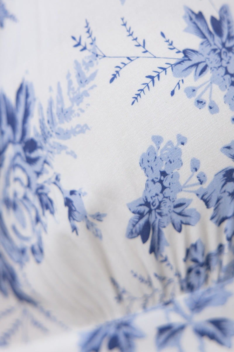 Close-up of blue floral pattern on Oceanside Wrap Midi Dress fabric, showcasing elegant design details.