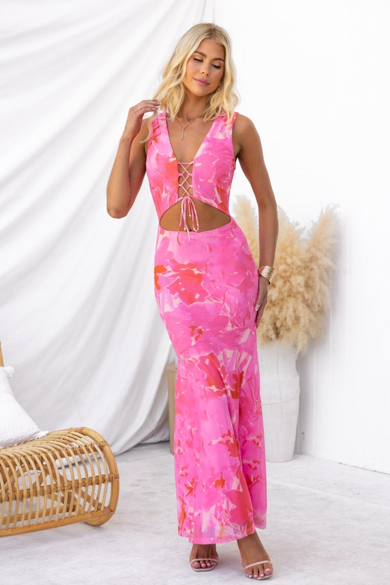 Model wearing a pink multi-colour Pisces maxi dress with a V-neckline and cut-out detail.