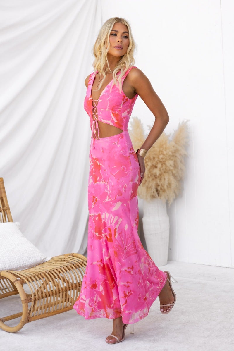 Multi-colour Pisces maxi dress on model, featuring V-neckline, tie detail, and cut-out waist design.