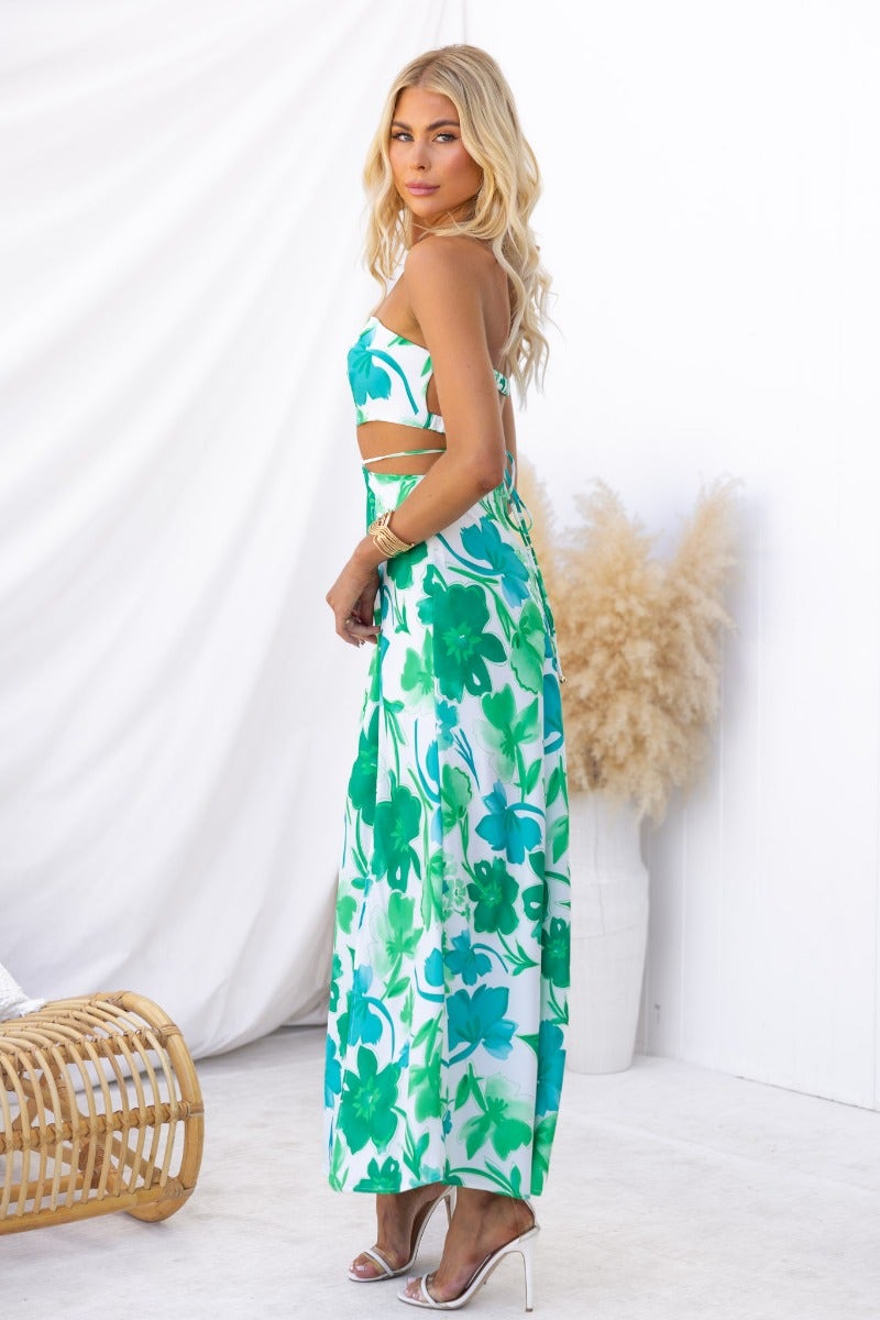 Zanita maxi dress featuring a floral print, cut-out waist, and strapless design, ideal for summer occasions.