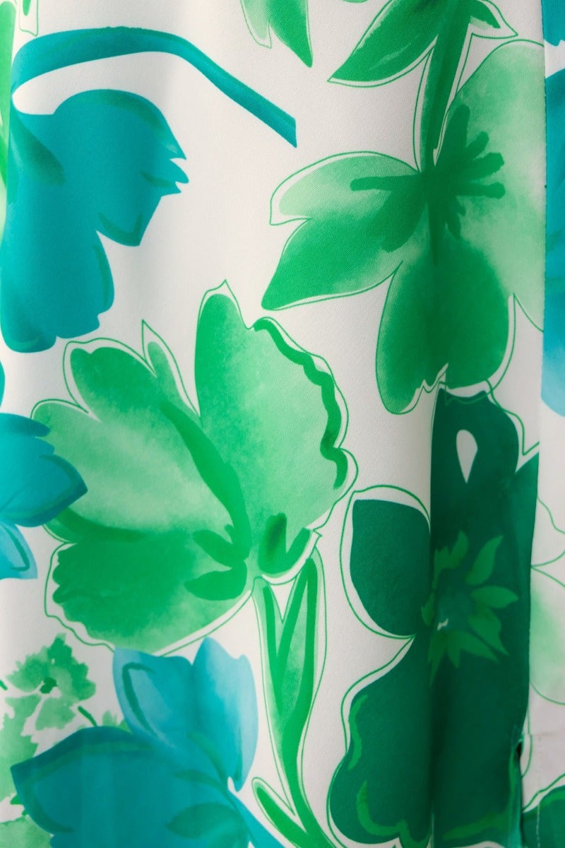Close-up of vibrant green floral print on a soft fabric, ideal for a stylish maxi dress.
