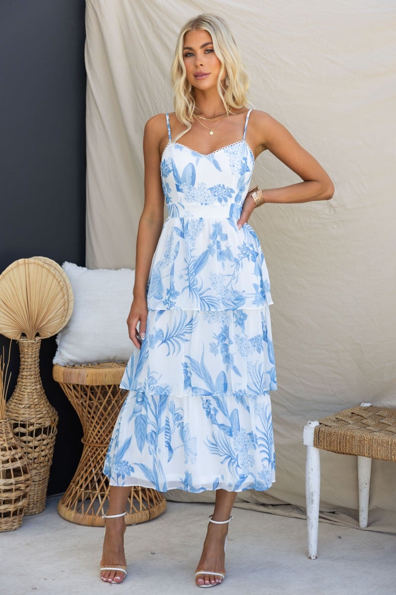 Model wearing In The Past midi dress featuring a floral print, ruffle skirt, and adjustable straps.