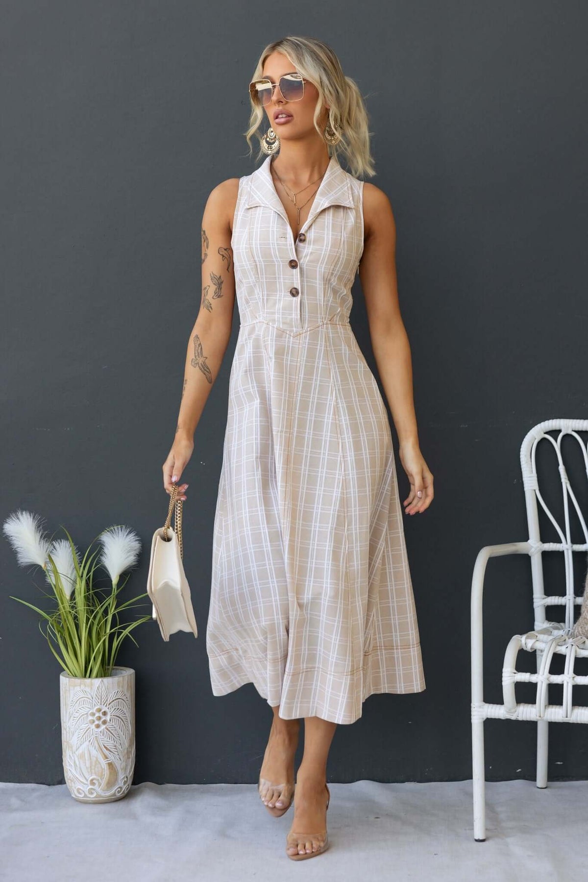 Harloh Midi Dress in beige plaid with collar, button-up bust, and side zip, styled with sunglasses and accessories.