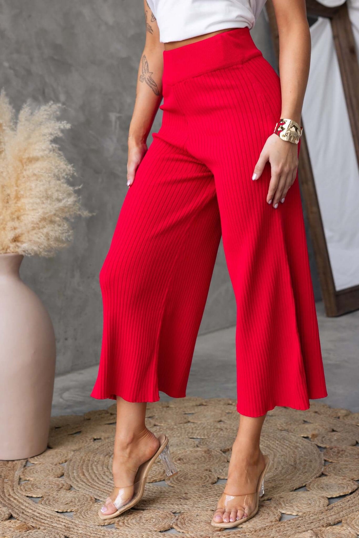 Dipsie Pants in vibrant red, featuring mid-high waist, elastic waistband, and ribbed knit material for a stylish look.