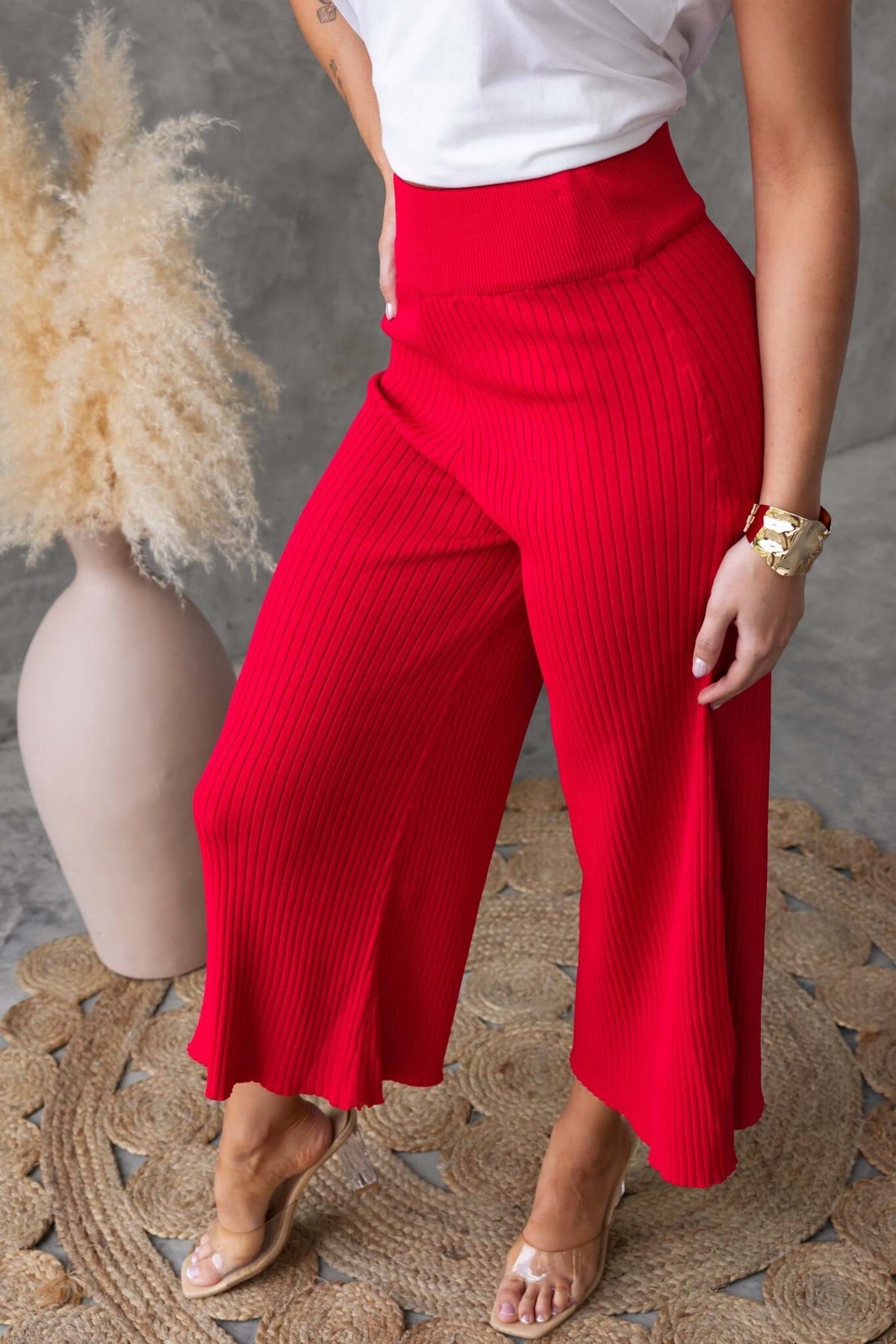 Dipsie Pants in vibrant red, featuring a mid-high waist, elastic waistband, and ribbed knit material with stretch.