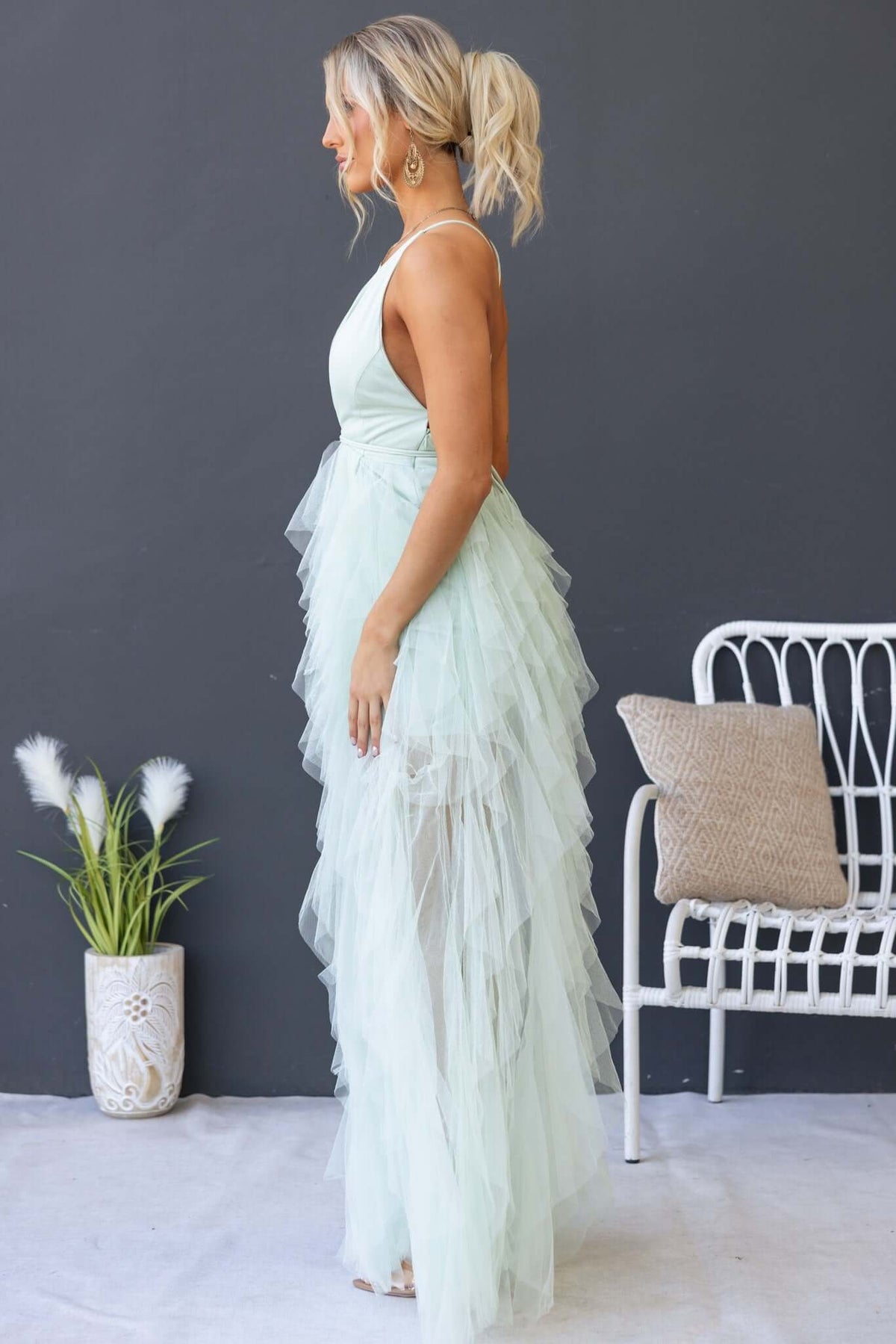 Model showcasing the Salinas Maxi Dress with tulle ruffles in mint green, side view against a neutral backdrop.