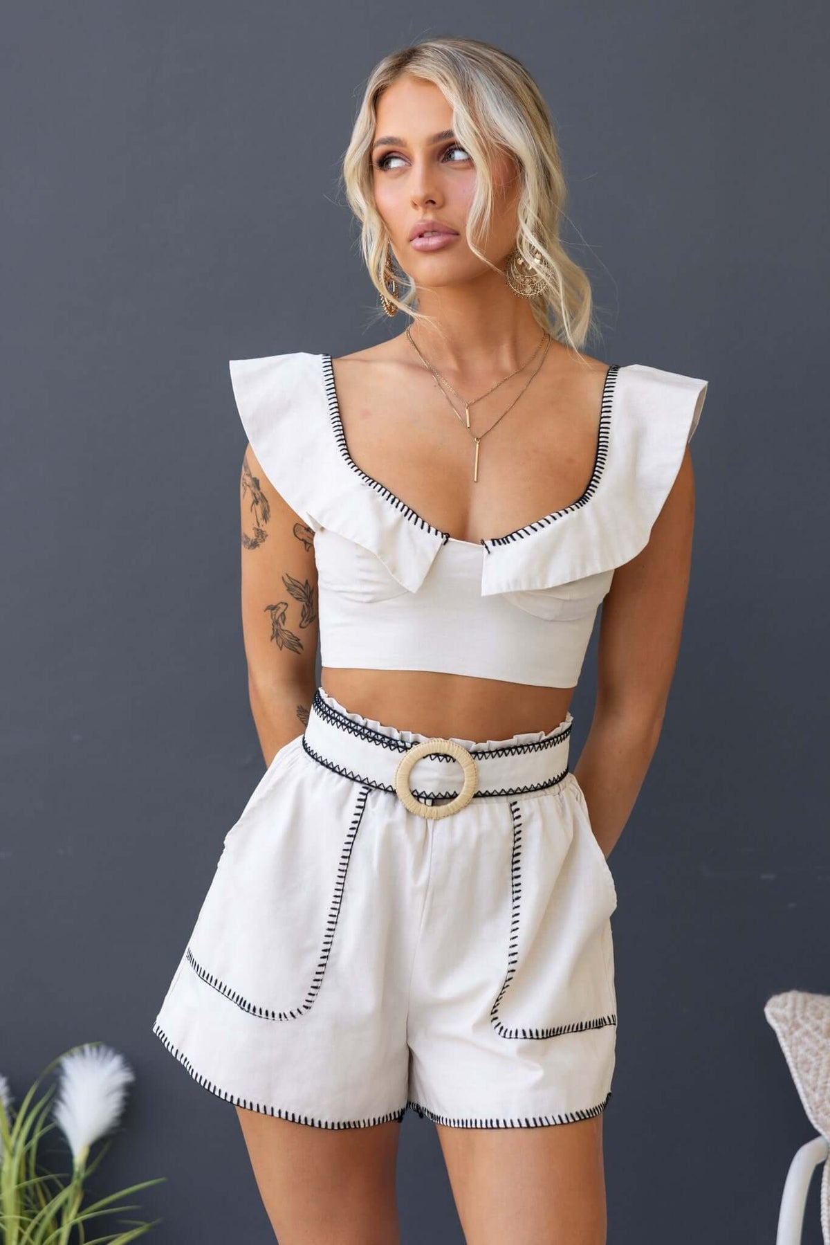 Valerio Set featuring a scoop neckline top with ruffles and mid-high waist shorts with a removable belt and pockets.