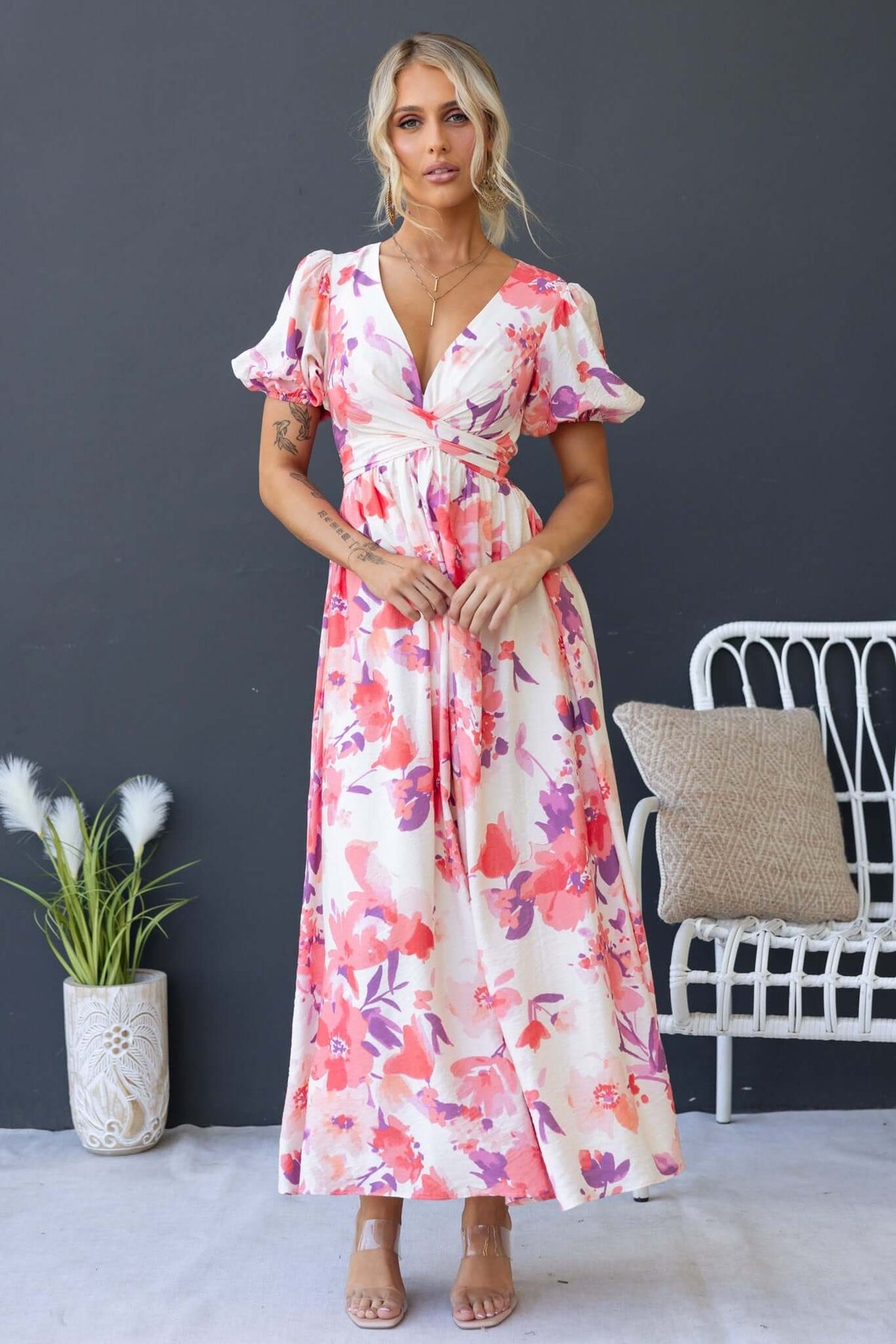 Tinsley Maxi Dress featuring a floral print, V-neckline, and tie waist, styled with elastic cuffs and a lined silhouette.