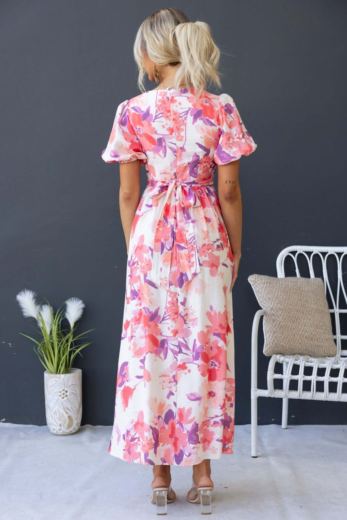 Back view of Tinsley Maxi Dress featuring floral print, V-neckline with tie, and elastic cuffs.