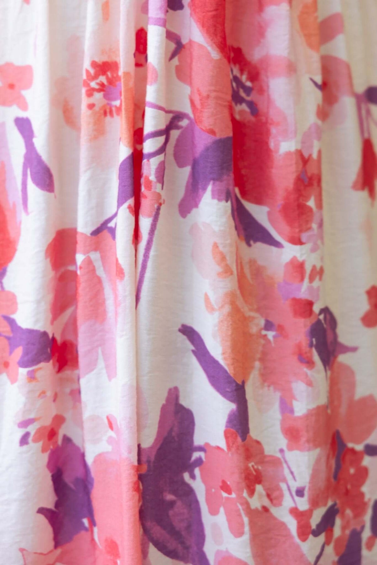 Close-up of floral print fabric featuring pink and purple flowers, ideal for the Tinsley Maxi Dress.