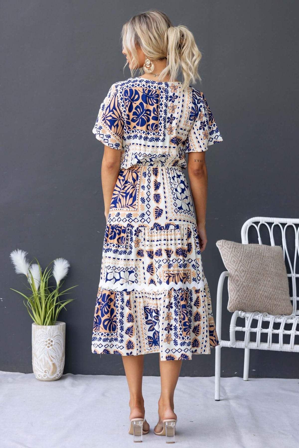 Back view of Virden Midi Dress featuring a blue and white patterned design, relaxed fit, and flutter sleeves.