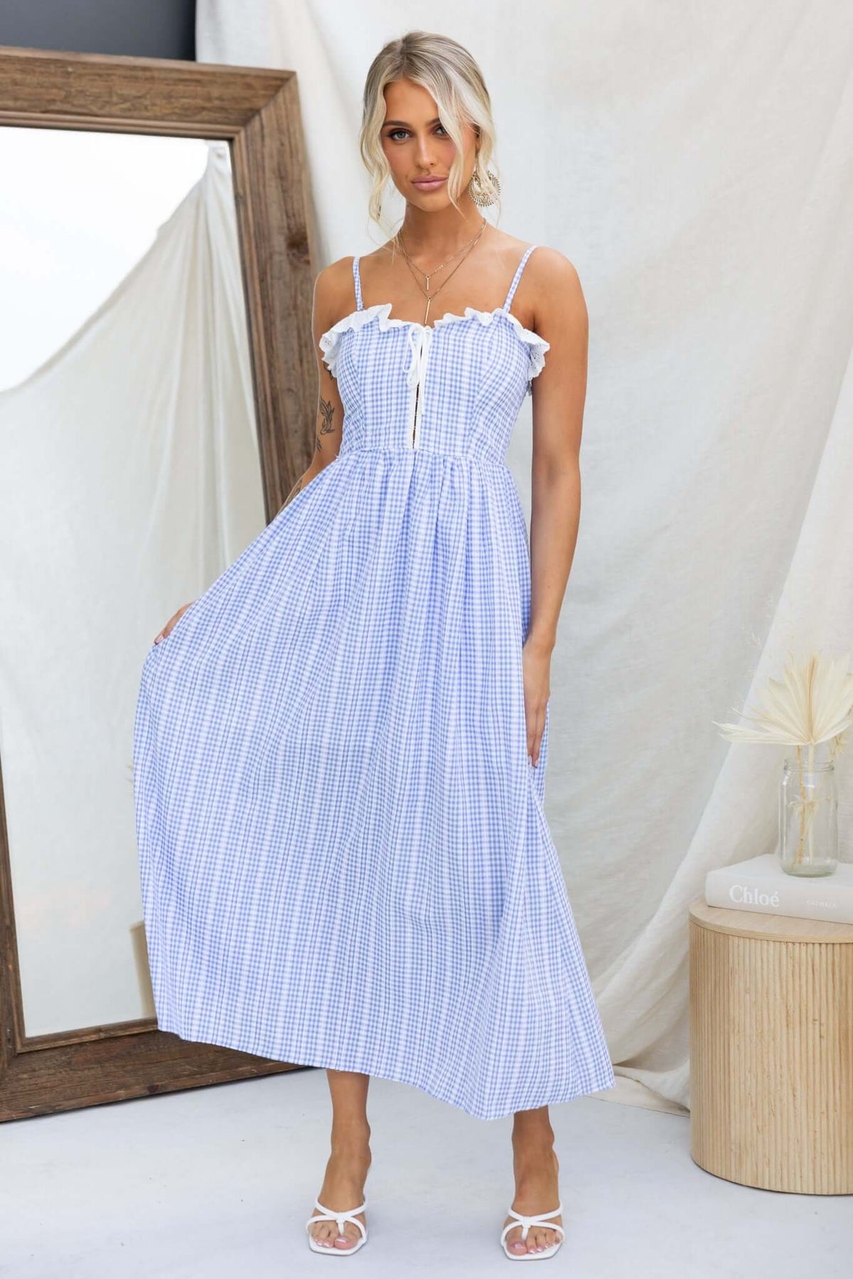 Model wearing the Endlessly Maxi Dress featuring adjustable straps and a cotton-like feel in a blue and white pattern.