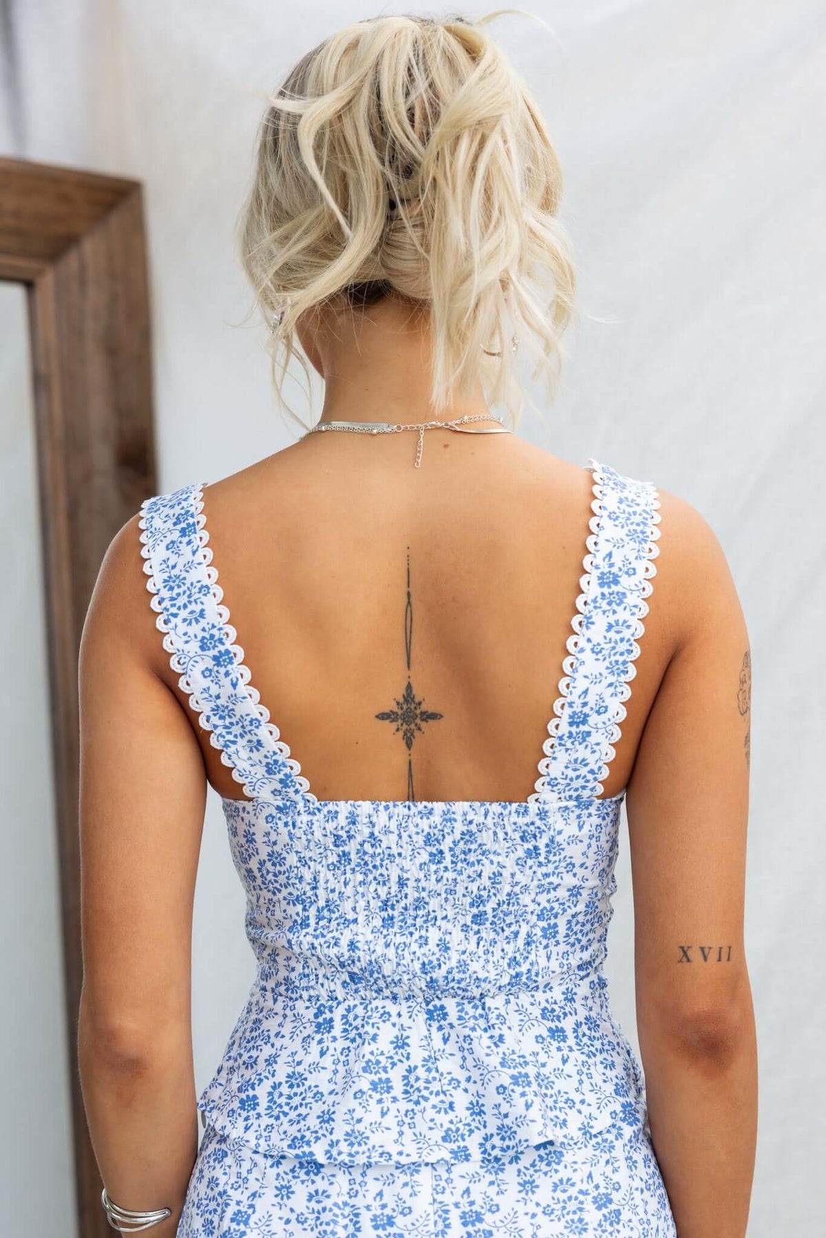 Ametrine Top featuring a square neckline, floral pattern, and decorative lace straps, seen from the back.