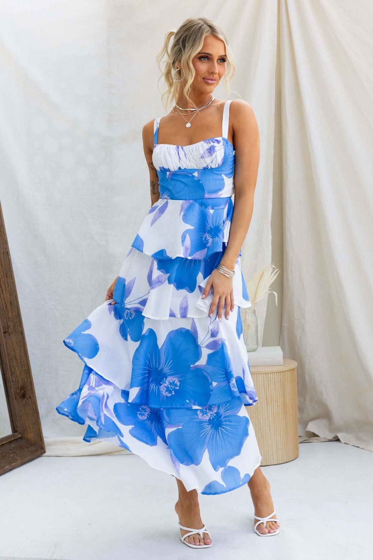 Peyton Maxi Dress featuring blue floral design, adjustable straps, multi-tier ruffle skirt, and elegant summer style.