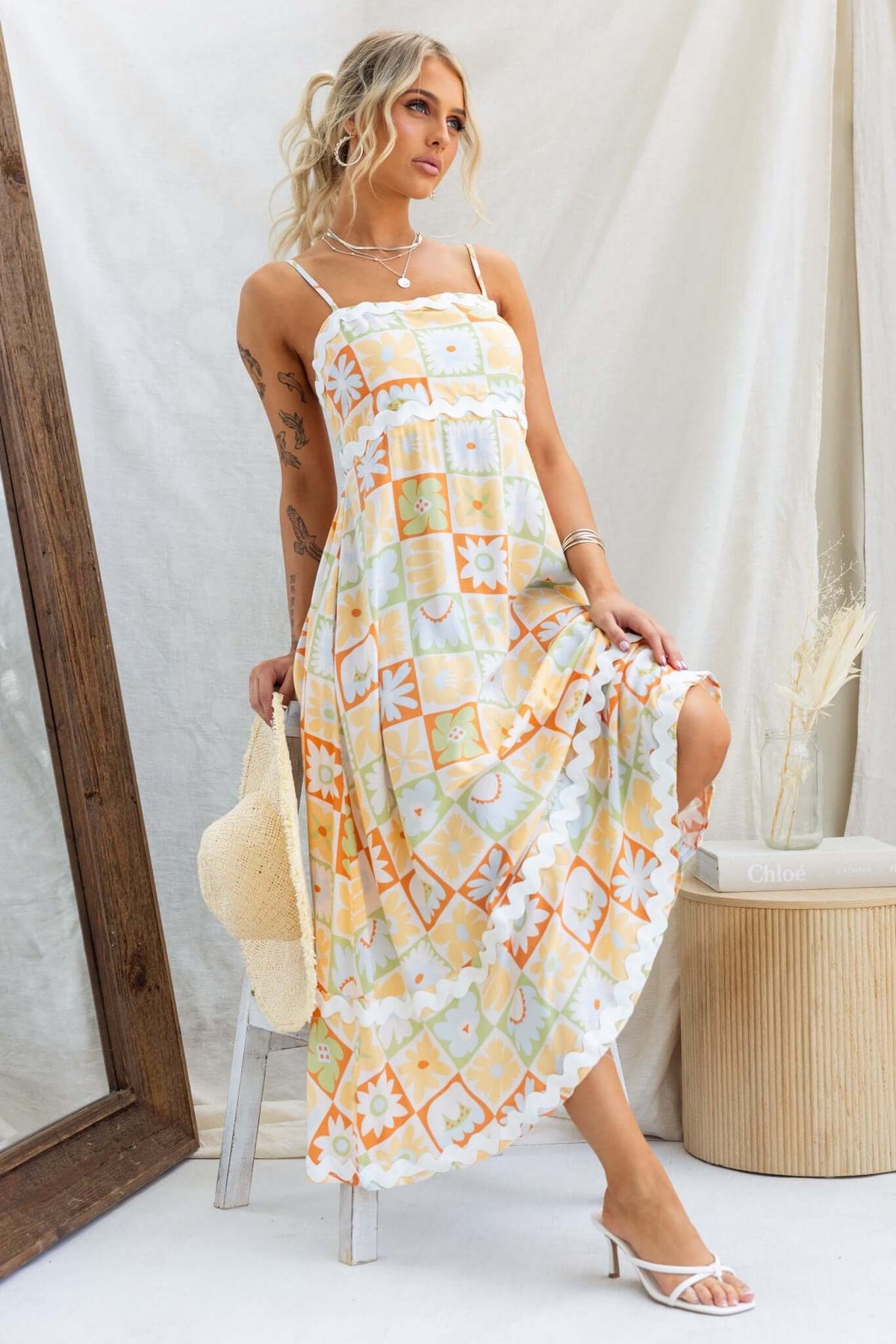 Model wearing the Nekoda Midi Dress featuring adjustable straps, floral pattern, and a relaxed fit.