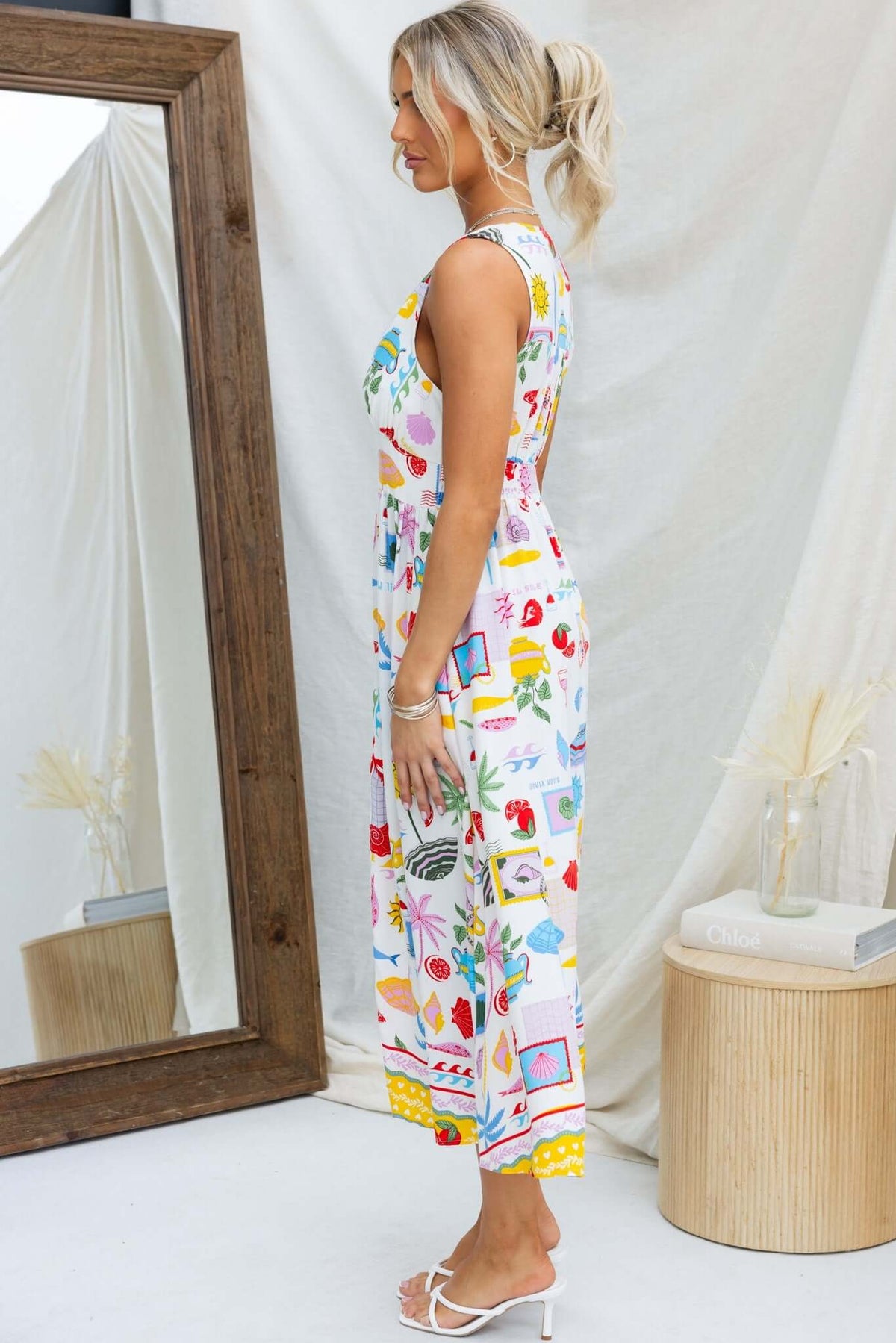 Side view of Juvena Midi Dress featuring colorful prints, a comfortable fit, and a sleeveless design.