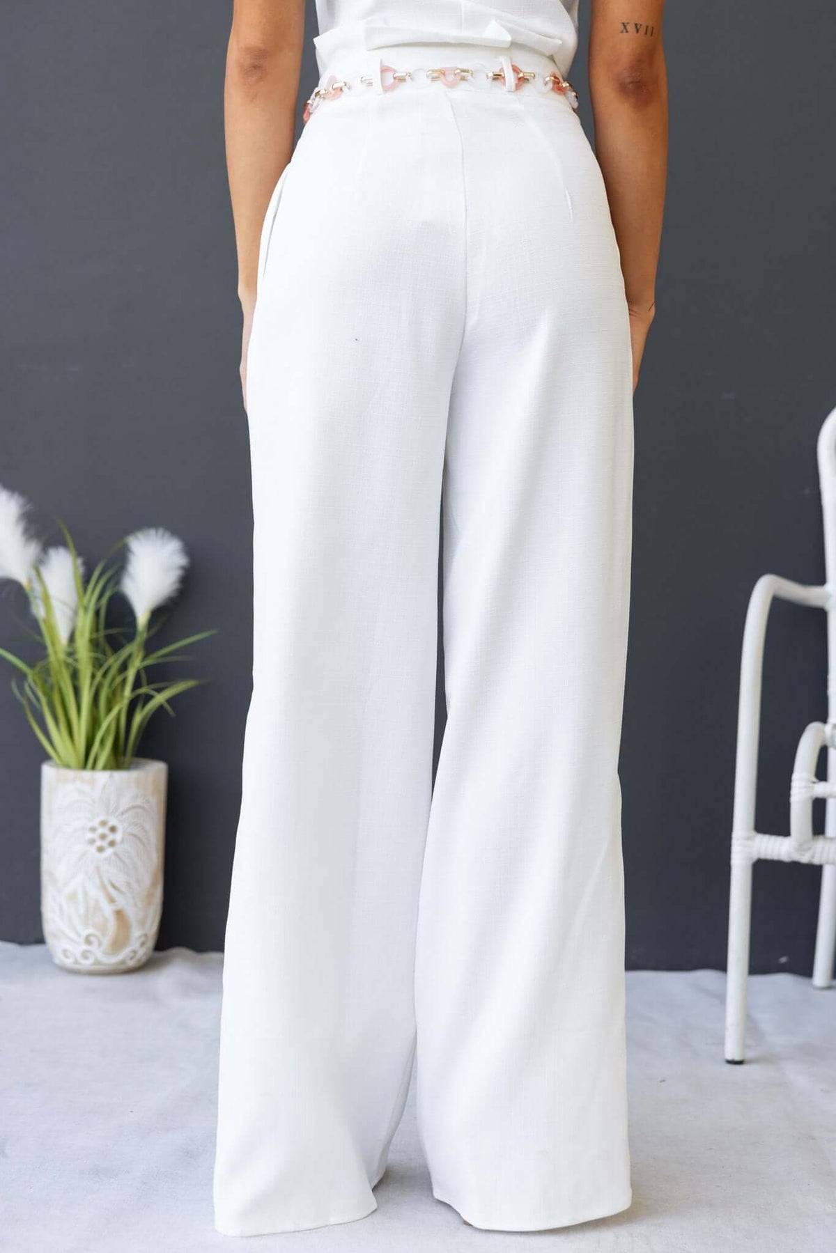 Back view of white Paytas Pants with paperbag waist and removable belt, showcasing a chic and stylish fit.