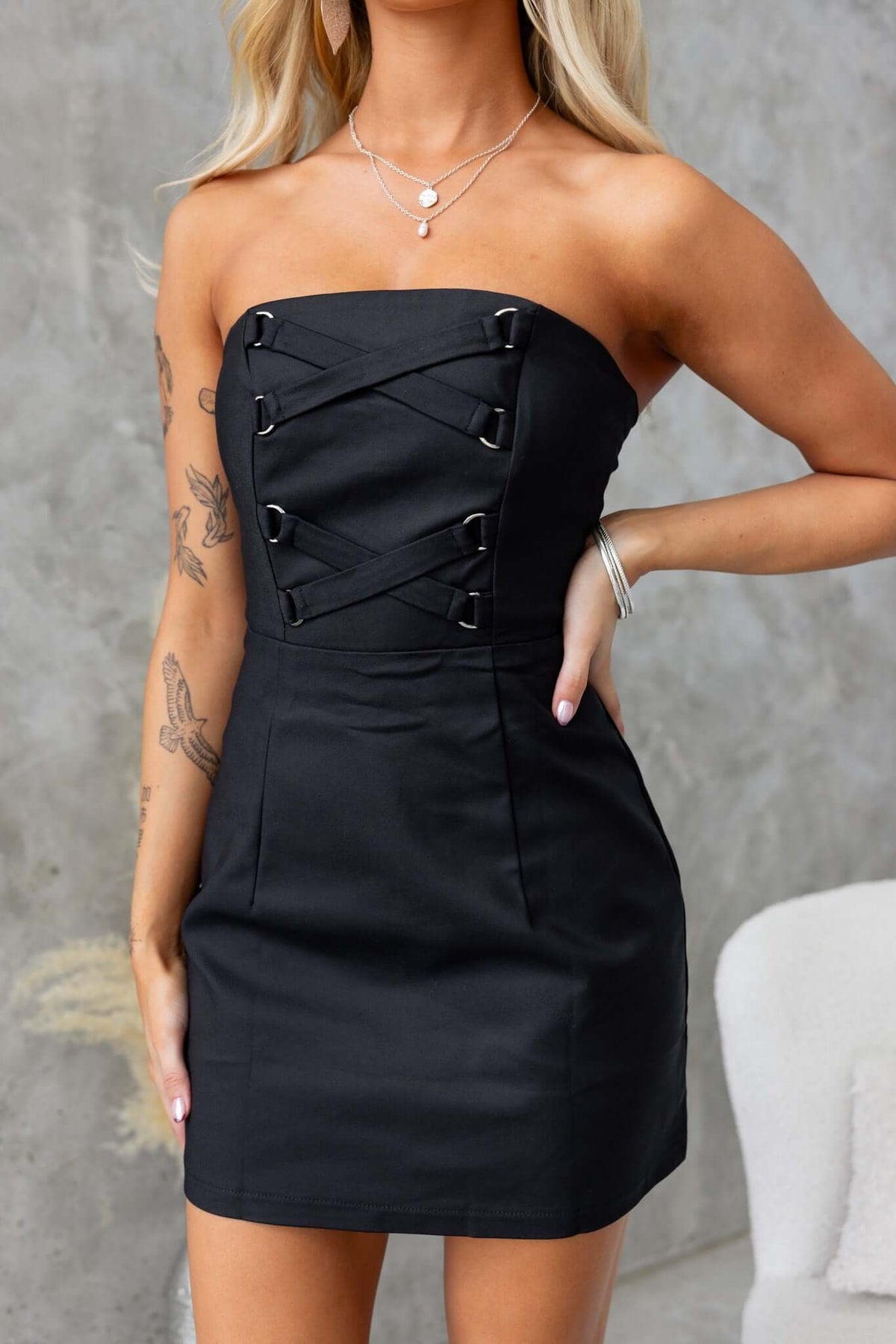 Strapless black Odelle dress featuring lace-up detailing and a fitted silhouette perfect for a night out.