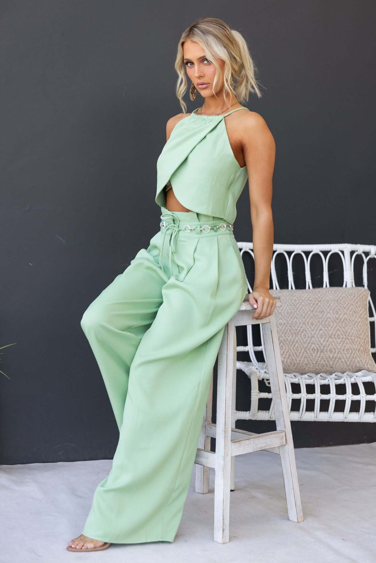 Model wearing Paytas Pants with paperbag waist and removable belt in light green color, styled for a chic look.