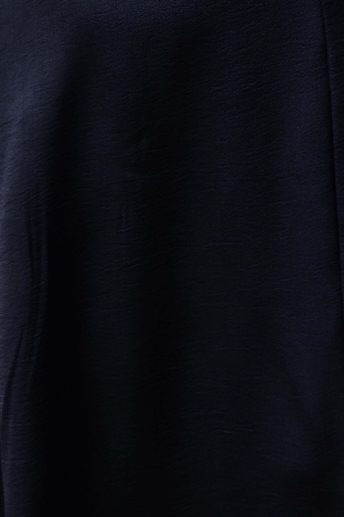 Close-up of Briony Maxi Dress fabric in black, showcasing its smooth satin texture and elegant drape.