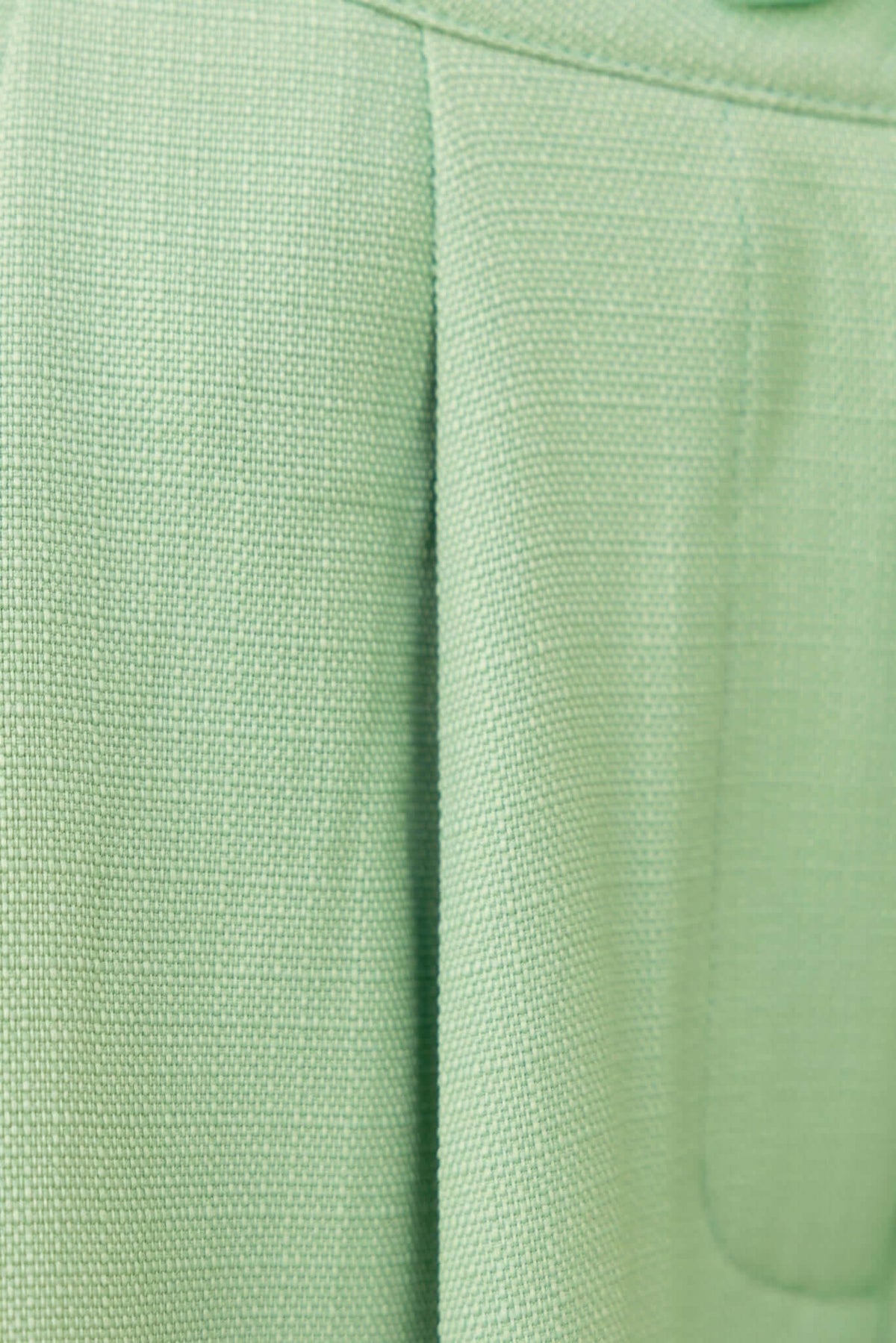 Close-up of soft, textured green fabric showcasing the linen-like look of the Paytas Top.