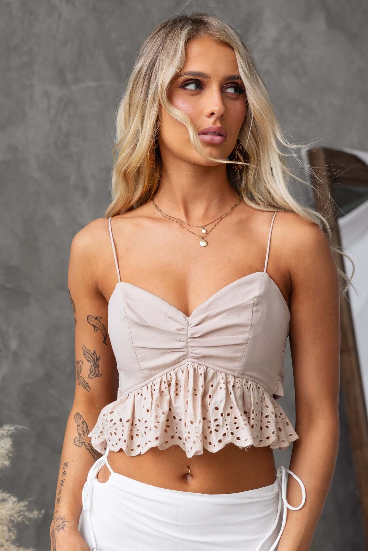 Model wearing Adams Top with adjustable straps, anti-slip bust, and frill hem in a stylish, neutral color.