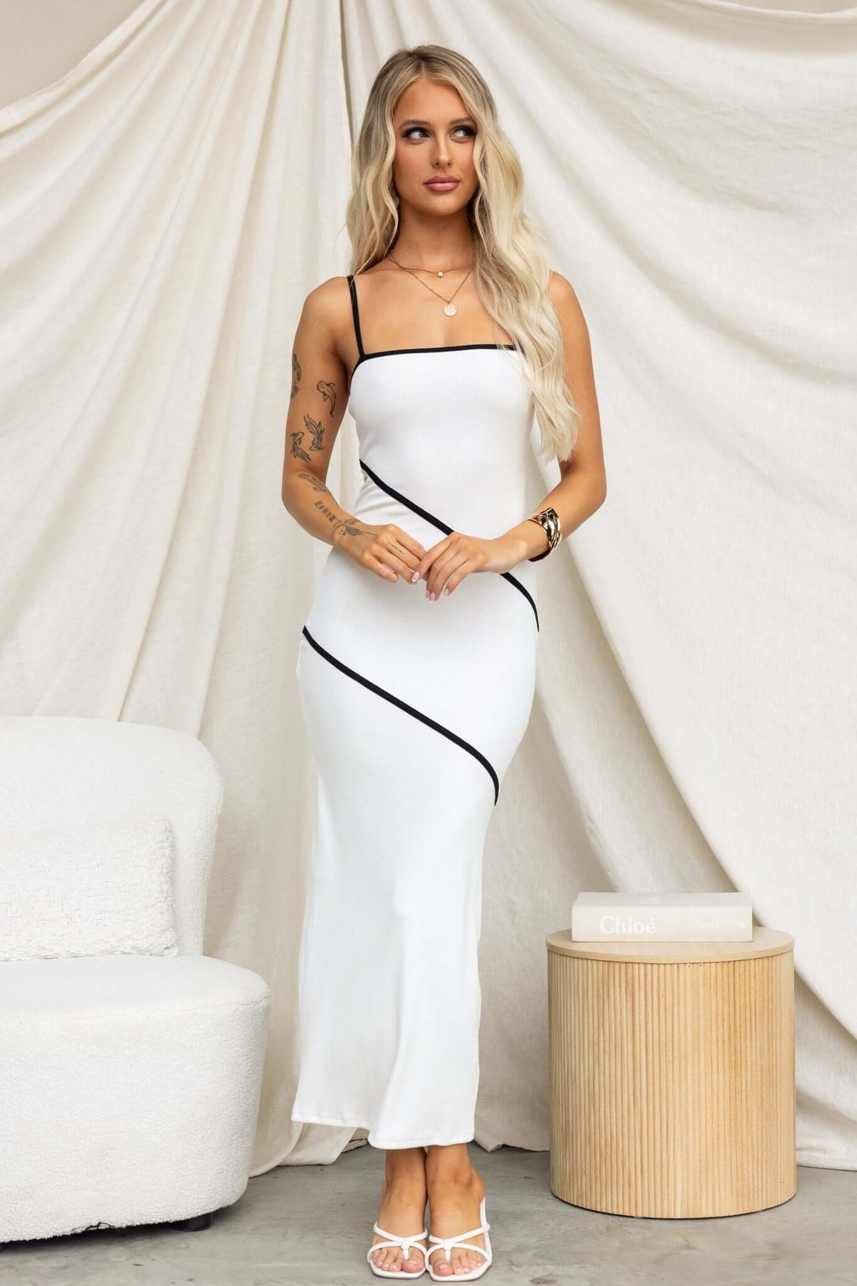 Model wearing Flossie Maxi Dress with adjustable straps and ribbed material against a soft backdrop.