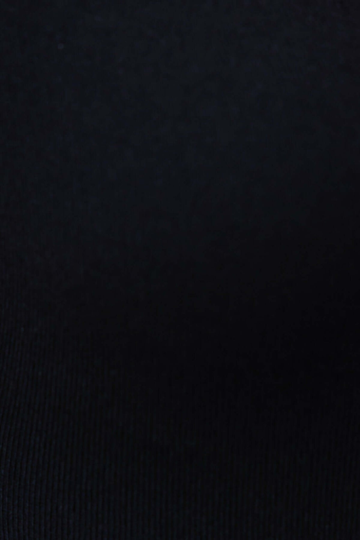 Close-up of the black knit fabric of the Denis Bodysuit, showcasing its soft texture and stretch.
