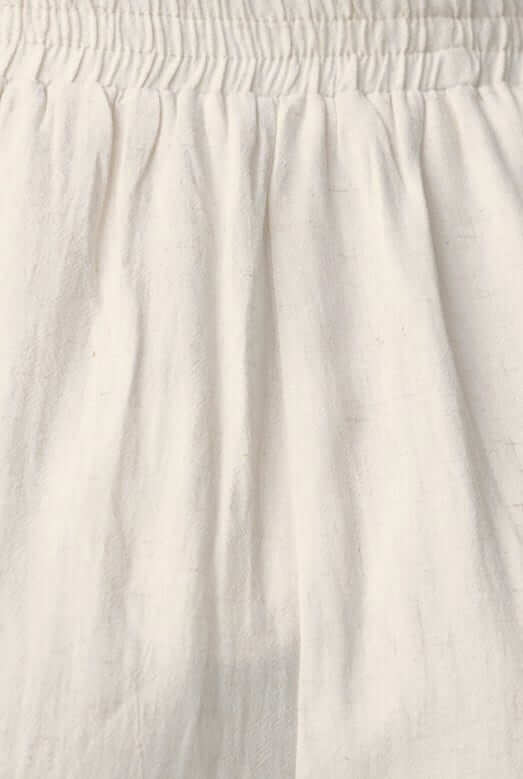Close-up of Mayok Shorts' elastic waistband and soft white fabric, showcasing the lightweight and comfortable design.