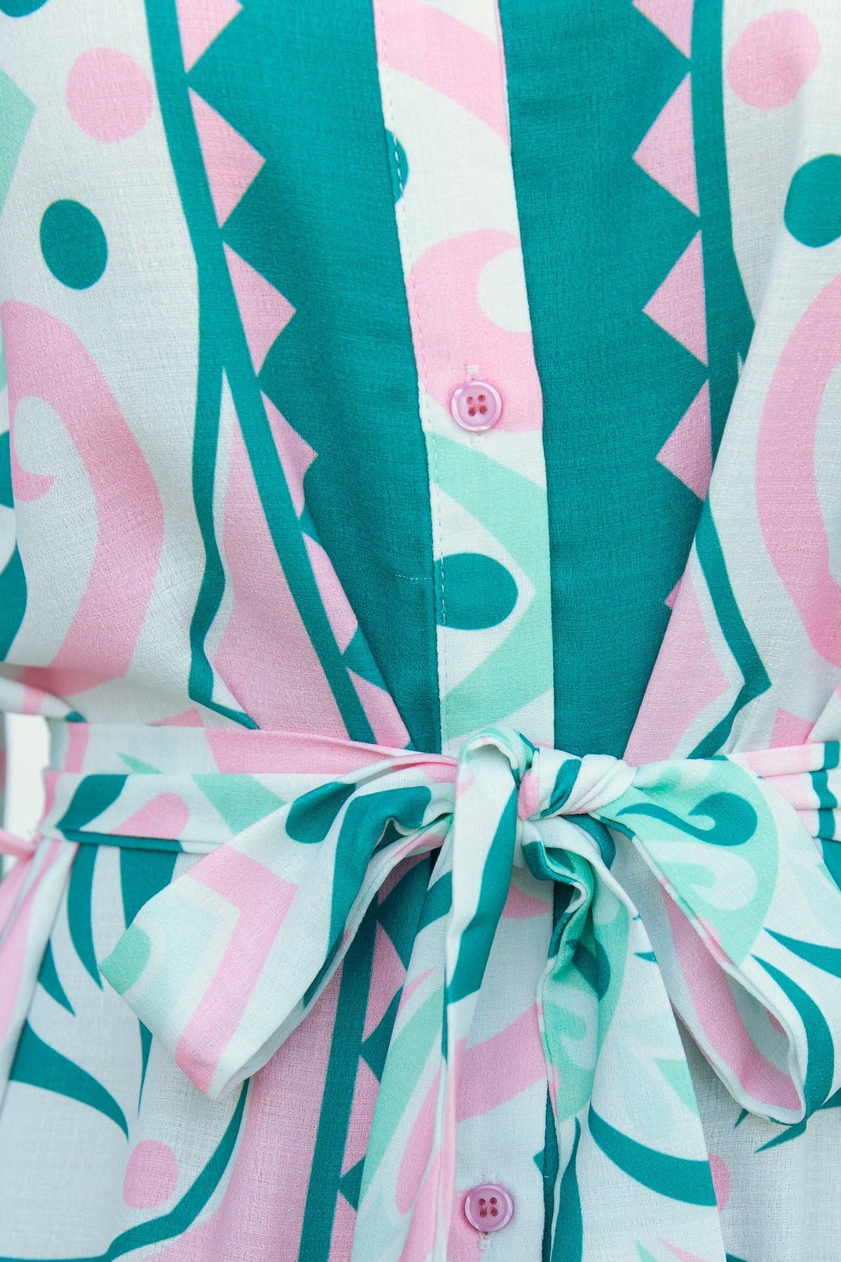 Close-up of the Faenza Midi Dress featuring colorful patterns, button-up front, and a tied waist detail.