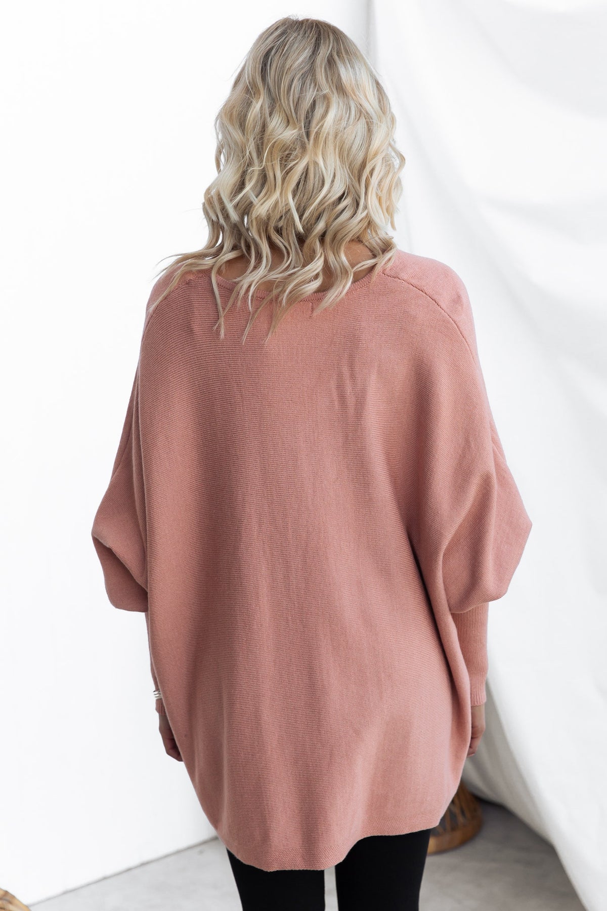 Brizzie Jumper in soft pink with batwing sleeves, showcasing V-neckline and oversized fit from the back.