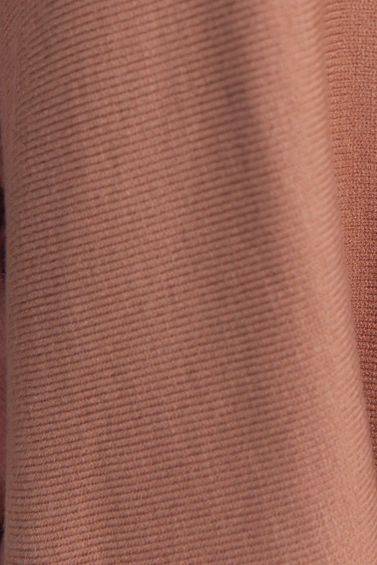 Close-up of Brizzie Jumper's knit material in warm brown, showcasing soft texture and internal ribbing detail.