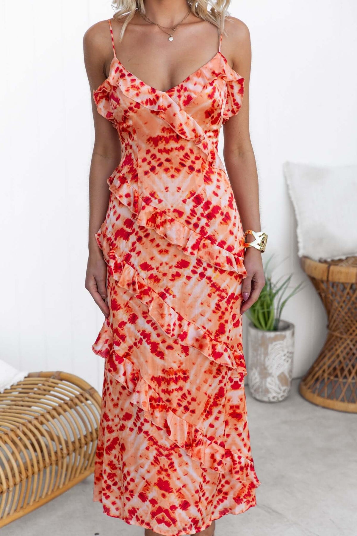 Model wearing a vibrant Aquarius Maxi Dress with adjustable straps and ruffle detailing, featuring a satin finish.
