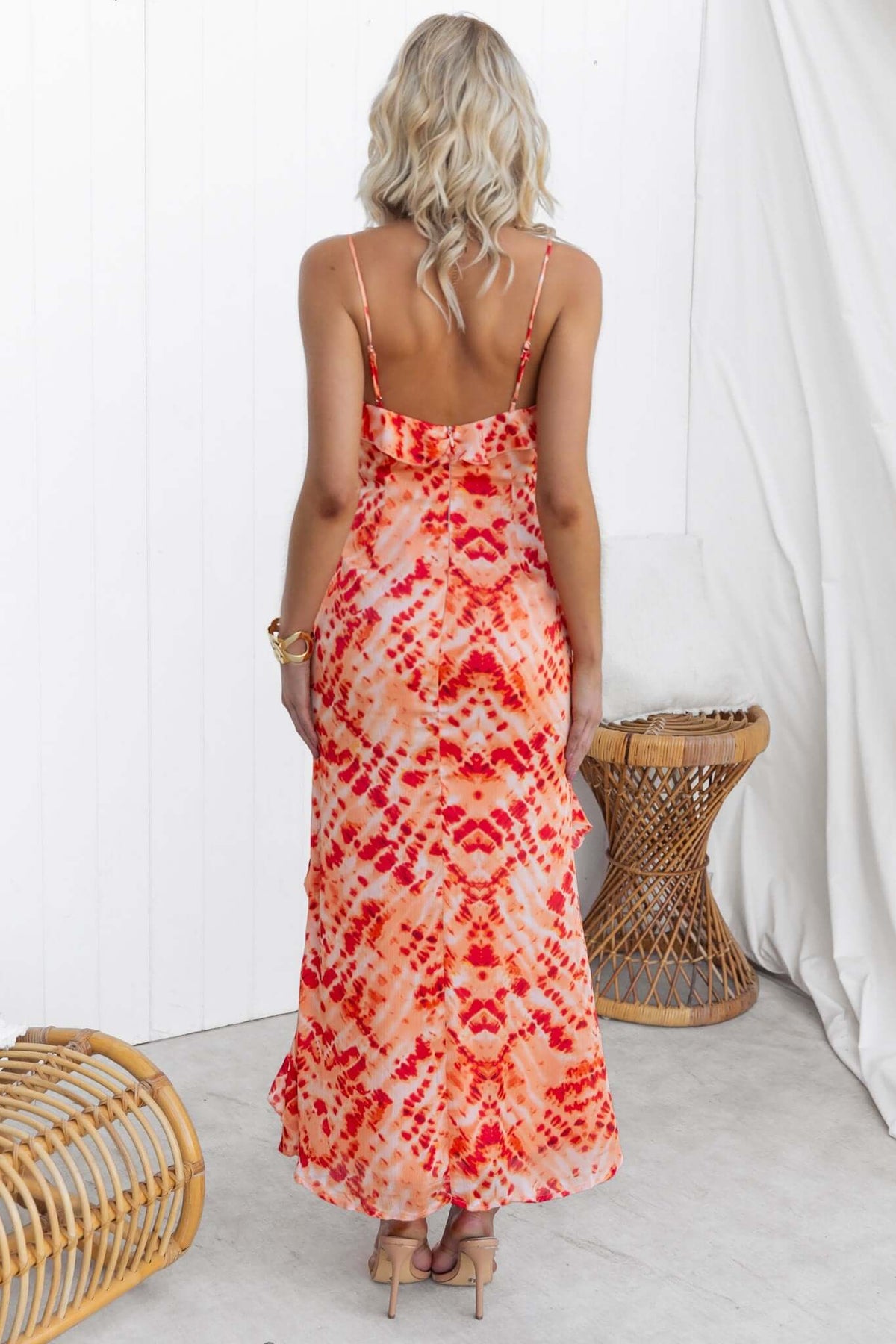 Back view of a vibrant orange Aquarius maxi dress with adjustable straps and ruffle detailing.