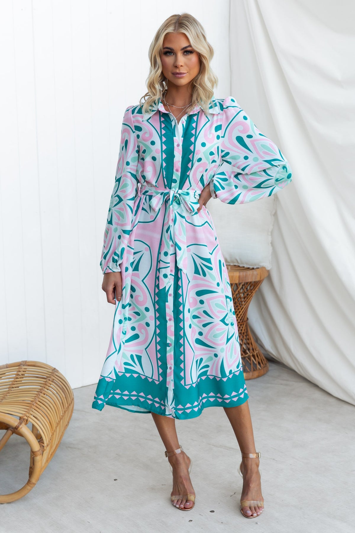 Faenza Midi Dress with vibrant pink and teal patterns, featuring a collar, button-up front, and removable tie.