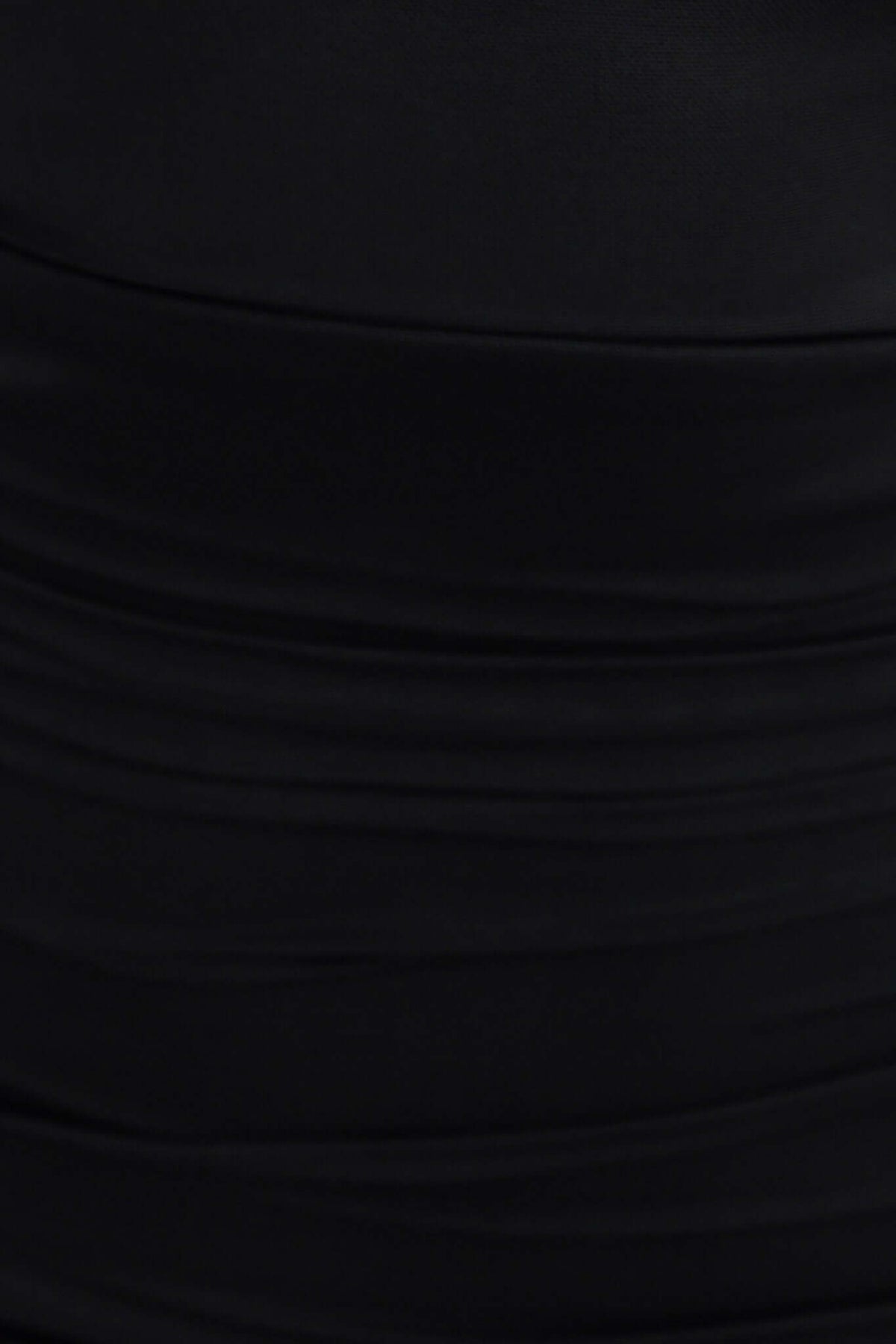 Close-up of the textured fabric of the black Dorado Dress, showcasing its stretch material and elegant style.
