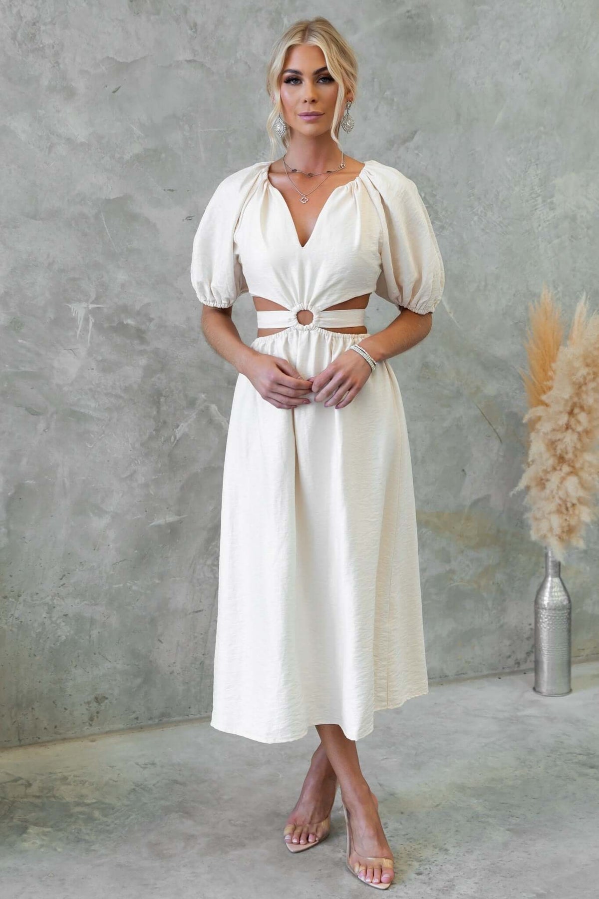 Isabelline midi dress with V-neckline, puff sleeves, cut-out waist, and fabric tie, perfect for stylish occasions.