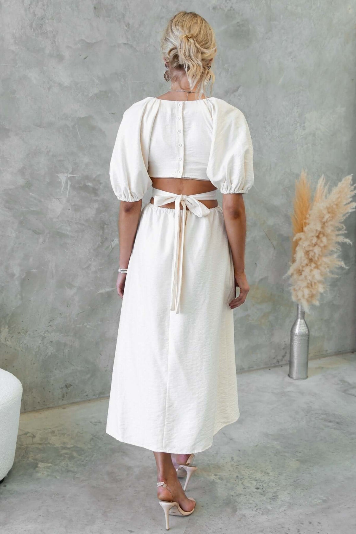 Back view of Isabelline Midi Dress featuring puff sleeves and a waist tie, perfect for casual or formal occasions.