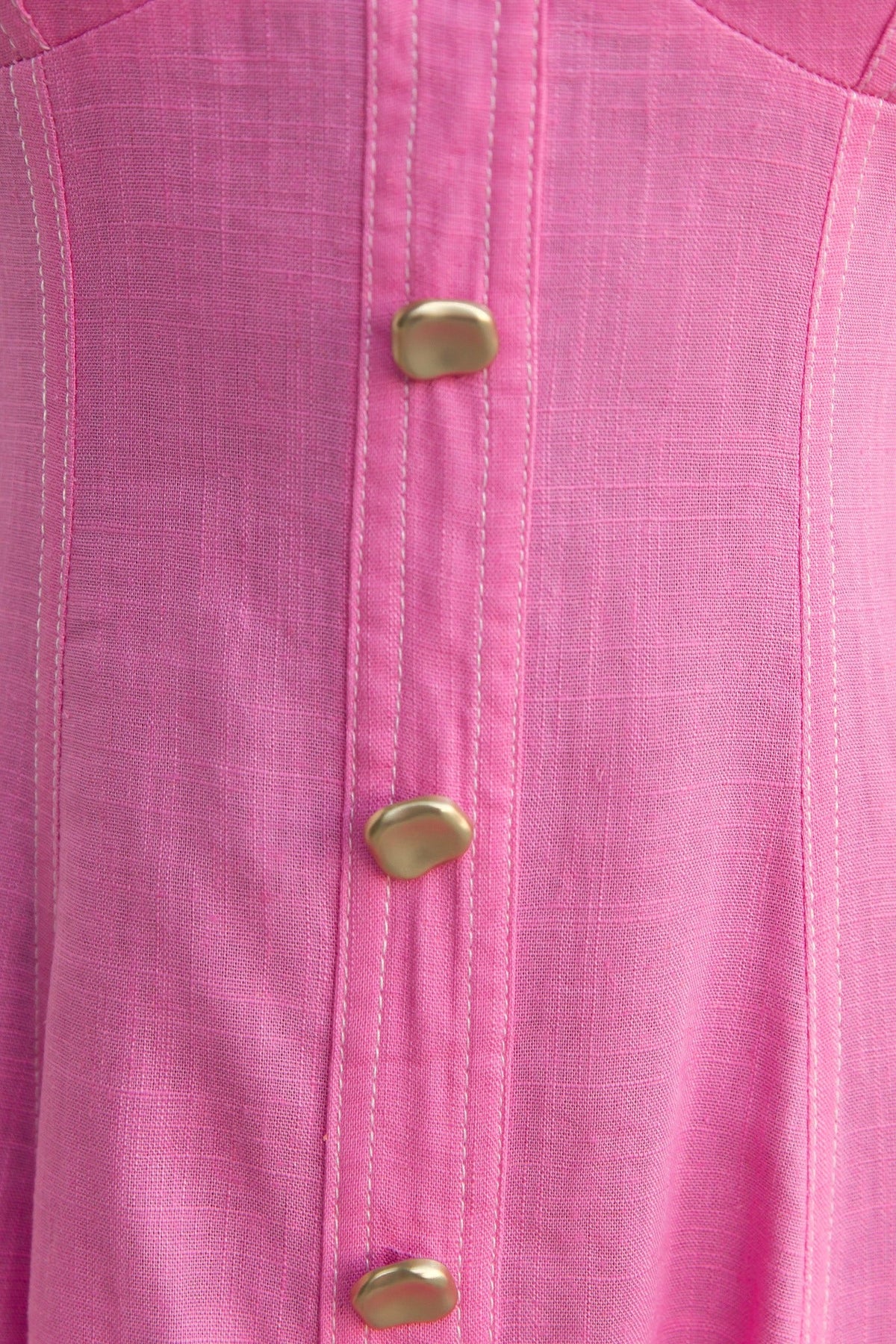 Close-up of pink Lyre Midi Dress featuring faux buttons and linen texture for a stylish, casual look.
